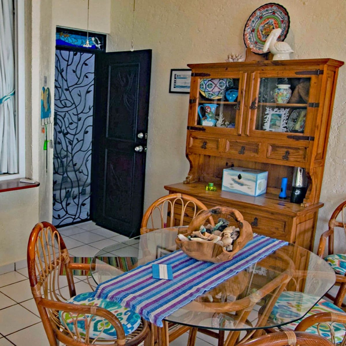 Seascape, La Sirena 1: The Dining Area with It's Iron Screen Door & Colorful Linenso the living room